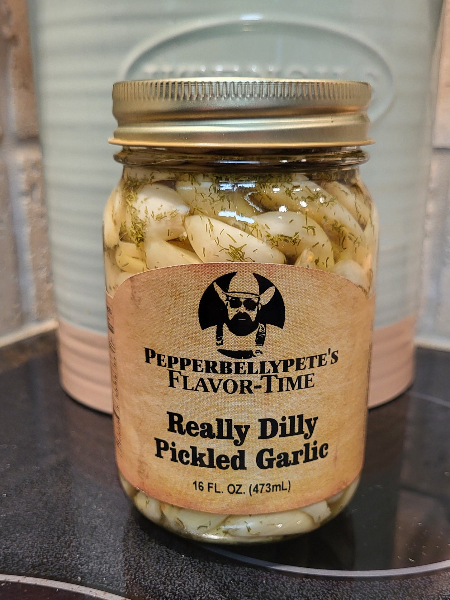 16 oz jar of Pepper Belly Pete’s Really Dilly Pickled Garlic, dill-brined garlic cloves stove