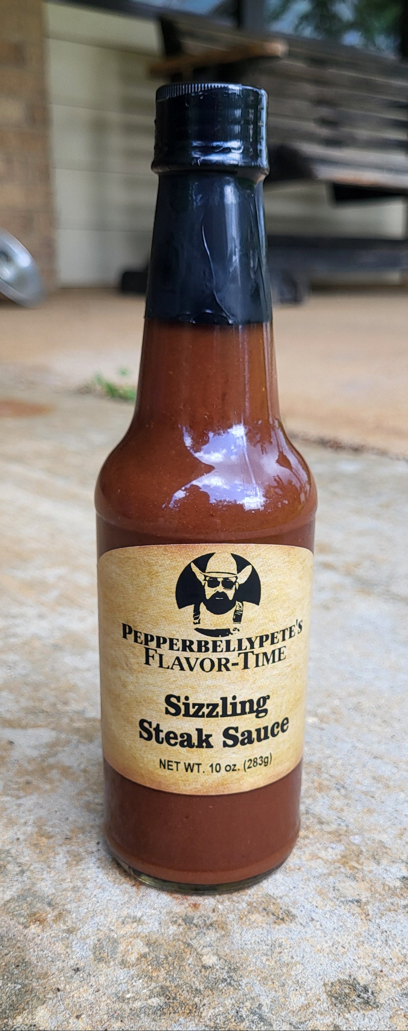 Bottle of Pepper Belly Pete's Steak & Burger Sauce - bold grilling flavor from Texas porch