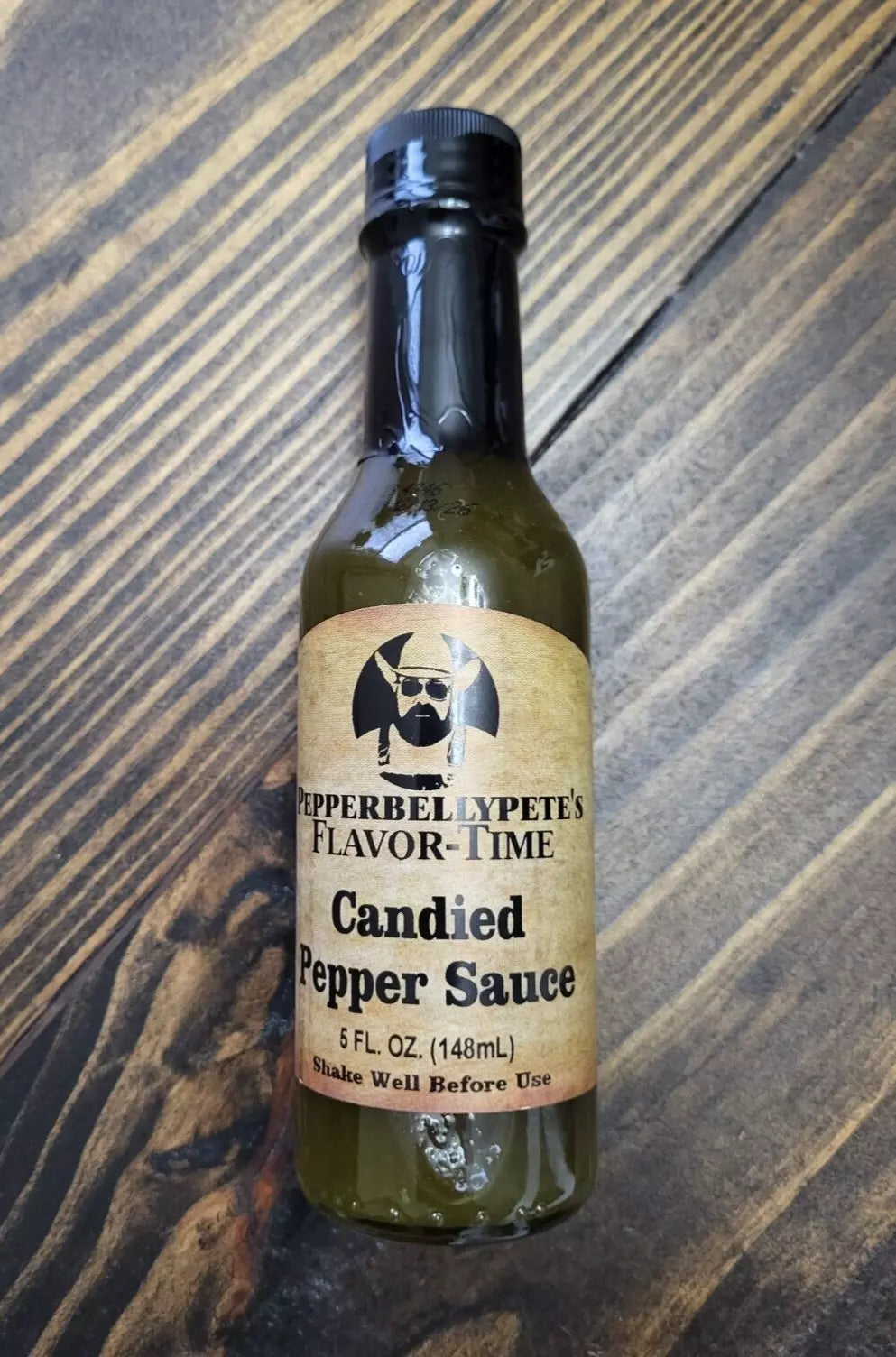 5 oz bottle of Pepper Belly Pete’s Candied Pepper Sauce – sweet-heat cowboy candy style wood
