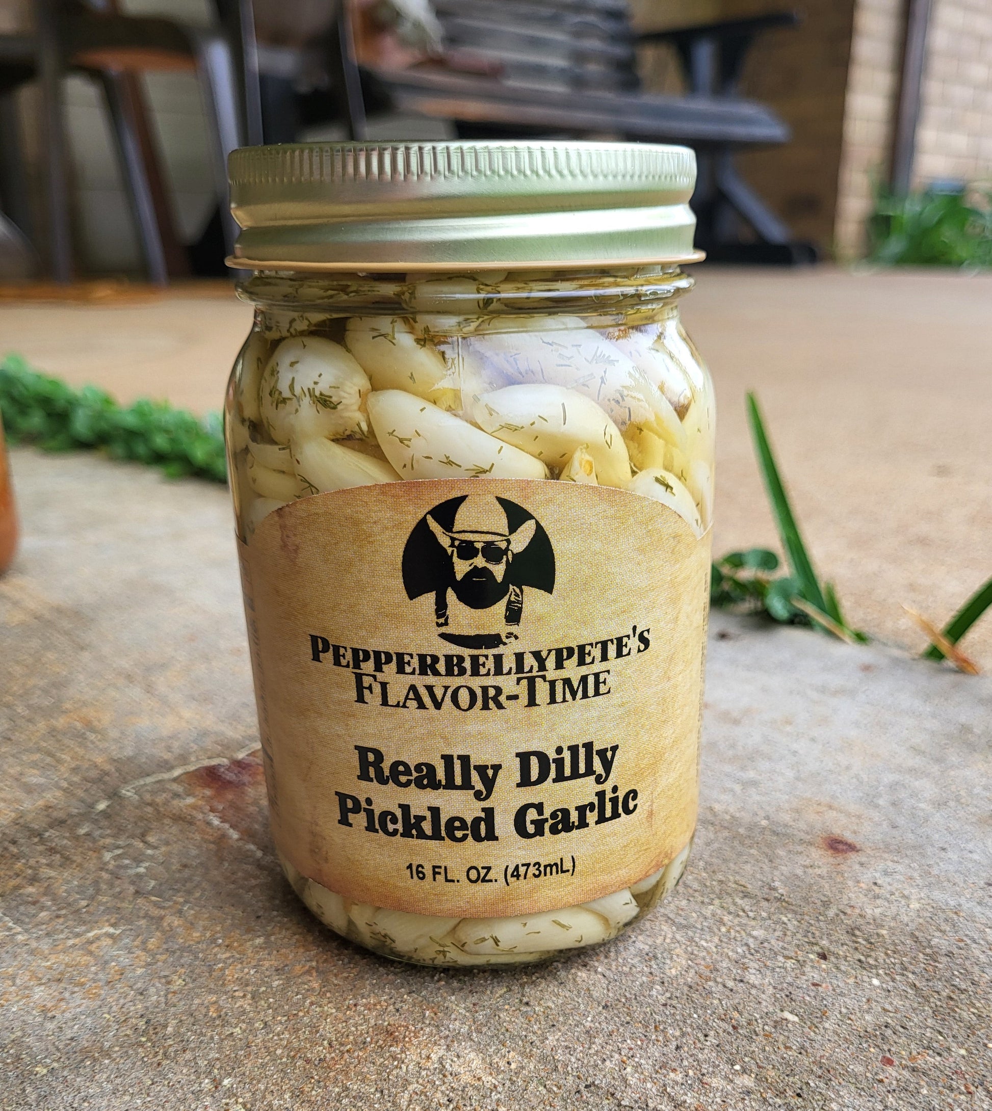 16 oz jar of Pepper Belly Pete’s Really Dilly Pickled Garlic, dill-brined garlic cloves porch